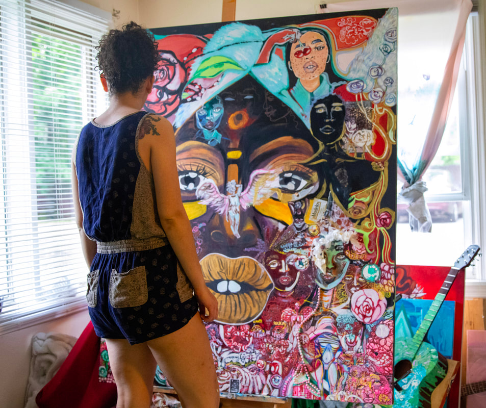 Maya James painting on-site